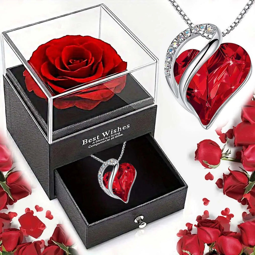 Heart-shaped red rose in a box with matching heart-shaped jewelry on a white background.